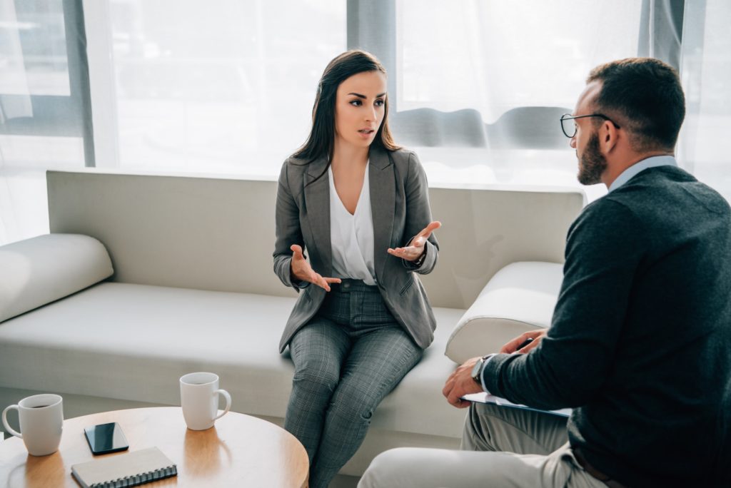 patient and therapist talking in doctors office