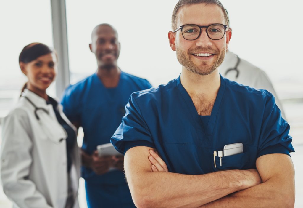 Young doctor in front of team